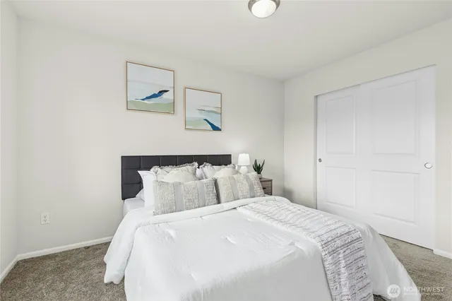 a bathroom with a granite countertop sink a toilet and a mirror