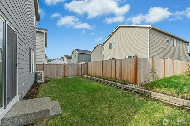 a view of a house with backyard and porch