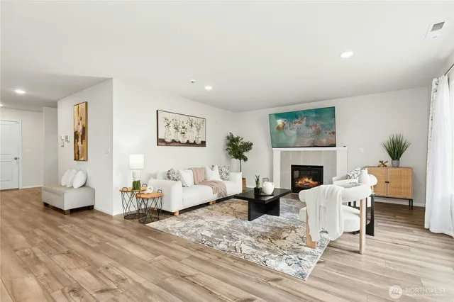 a living room with furniture a fireplace and a table