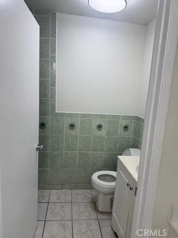 a white toilet sitting next to a bathroom sink