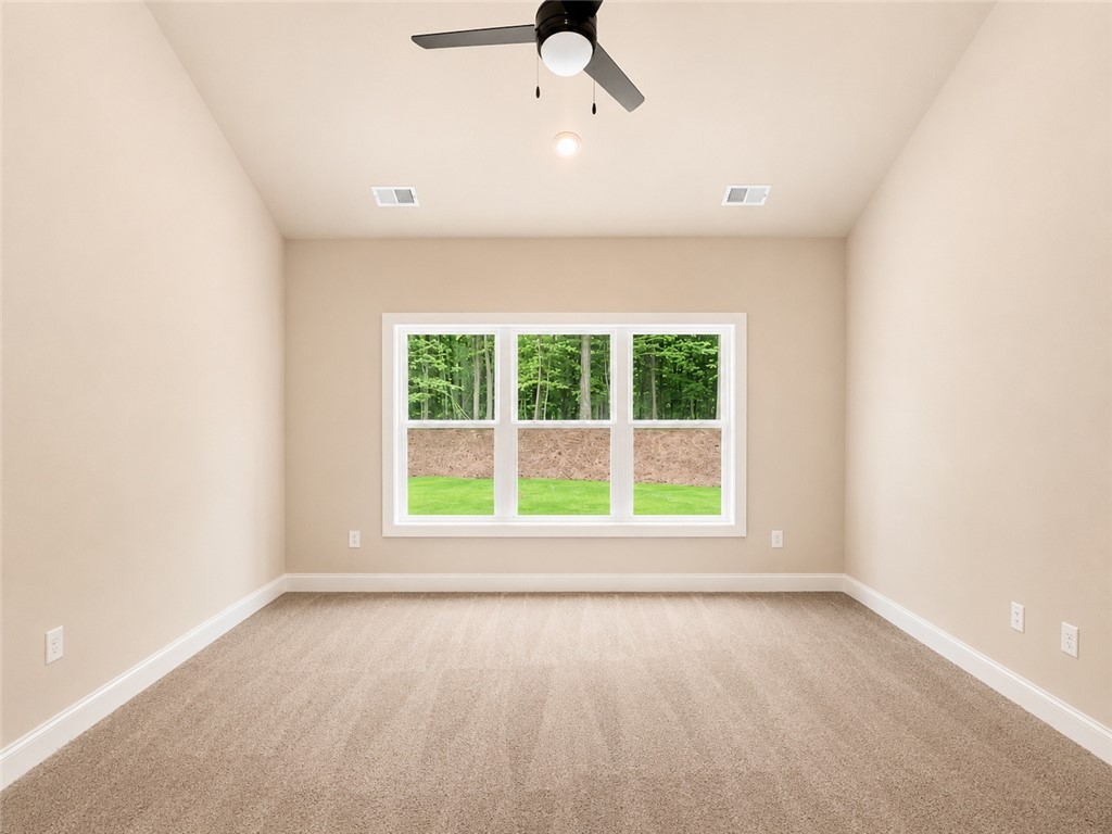 328 Point Road Westminster, SC 29693 - Photo 8 of 24 A quiet space with soft carpet offers a peaceful view of natural surroundings through an expansive window.