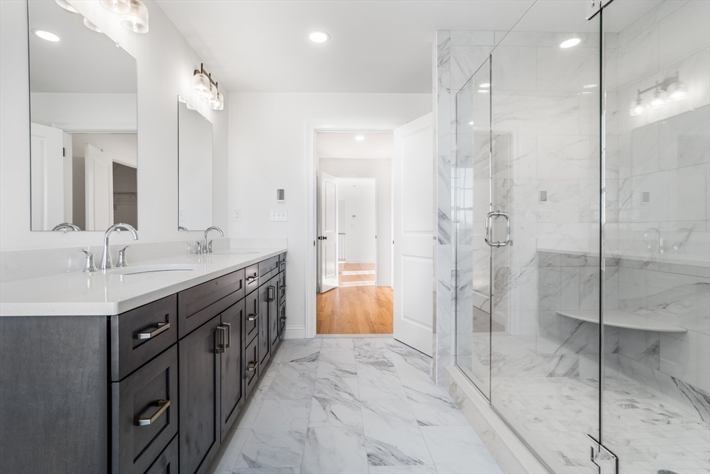 62 High Street, Unit LOT 7 Stoneham, MA 02180 - Photo 12 of 19 a bathroom with a double vanity sink mirror and shower