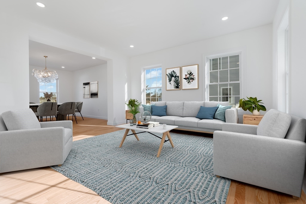 62 High Street, Unit LOT 7 Stoneham, MA 02180 - Photo 2 of 19 a living room with furniture and wooden floor