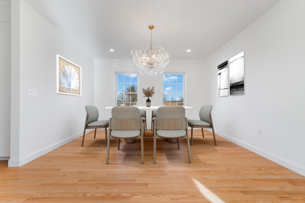 62 High Street, Unit LOT 7 Stoneham, MA 02180 - Photo 3 of 19 a view of a dining room with furniture and wooden floor