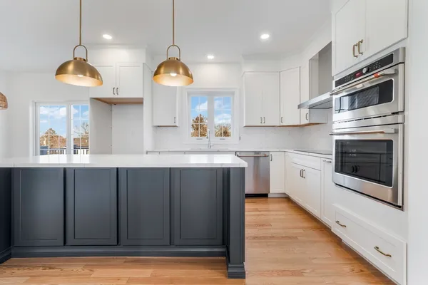a kitchen with a sink stainless steel appliances and cabinets
