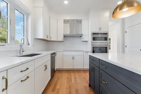 a kitchen with cabinets appliances and a counter space