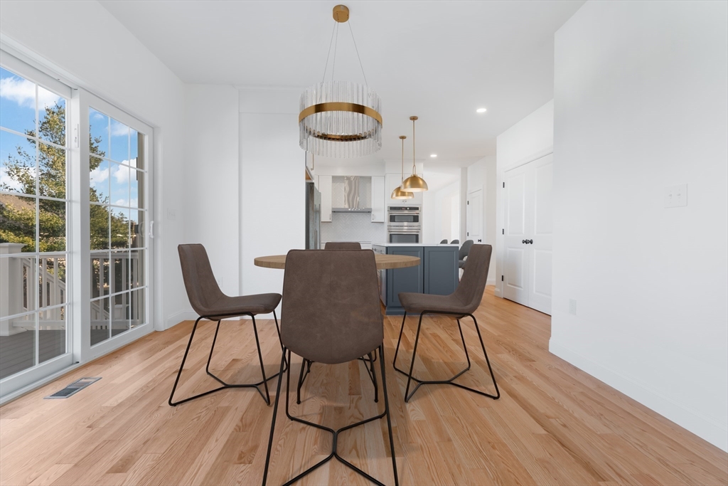 62 High Street, Unit LOT 7 Stoneham, MA 02180 - Photo 7 of 19 a view of a dining room with furniture and wooden floor