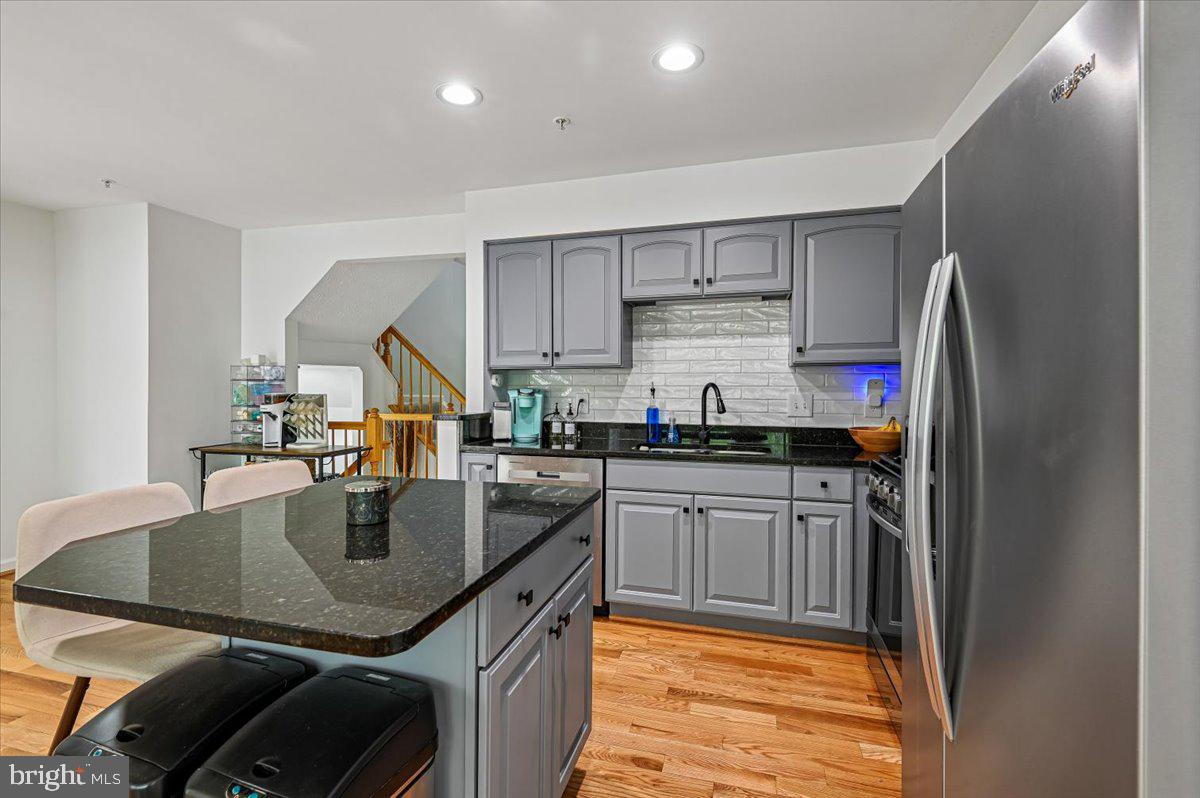 2401 High Brandy Way Odenton, MD 21113 - Photo 11 of 61 a kitchen with stainless steel appliances granite countertop a sink refrigerator and cabinets