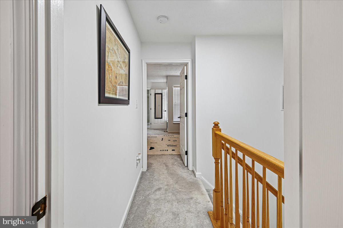 2401 High Brandy Way Odenton, MD 21113 - Photo 19 of 61 a view of a hallway with wooden floor and a bathroom