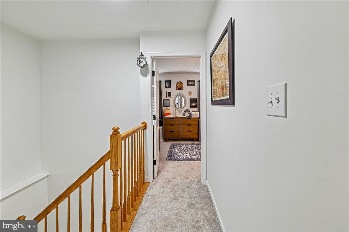 2401 High Brandy Way Odenton, MD 21113 - Photo 20 of 61 a view of a hallway with wooden floor and staircase