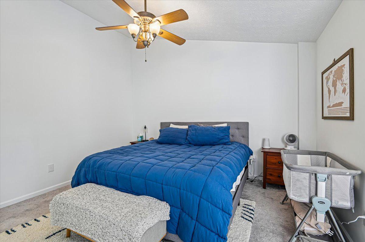 2401 High Brandy Way Odenton, MD 21113 - Photo 22 of 61 a bedroom with a bed and a chandelier