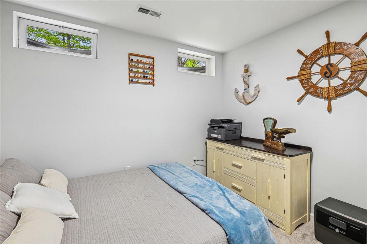 2401 High Brandy Way Odenton, MD 21113 - Photo 39 of 61 a bedroom with a bed and a chandelier
