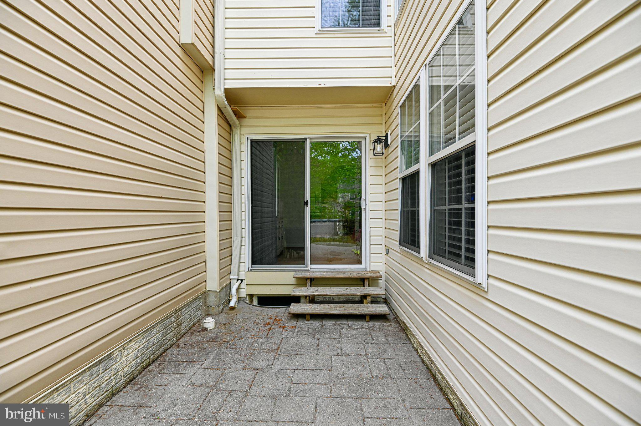 2401 High Brandy Way Odenton, MD 21113 - Photo 47 of 61 a view of a patio with a door and a large tree