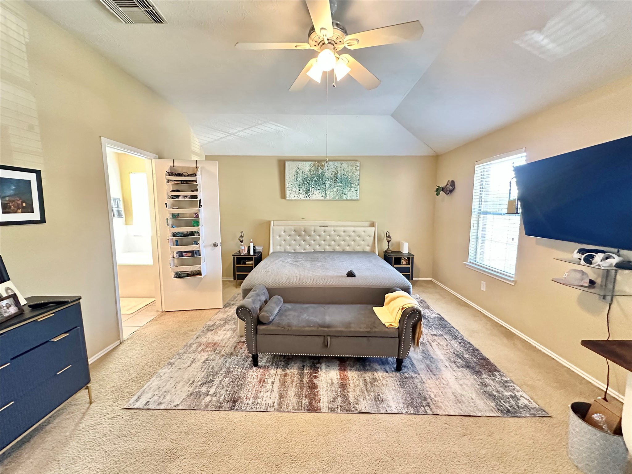 5107 Bright Oak Court Spring, TX 77373 - Photo 11 of 19 a spacious bedroom with a bed a dresser and a flat screen tv