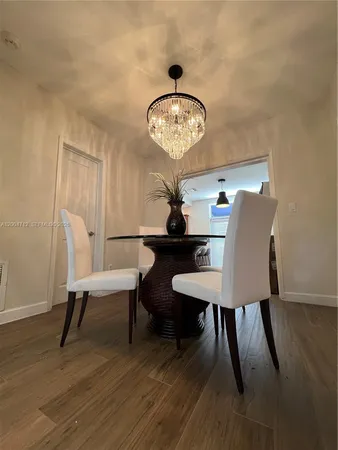 a large bed sitting in a bedroom next to a lamp