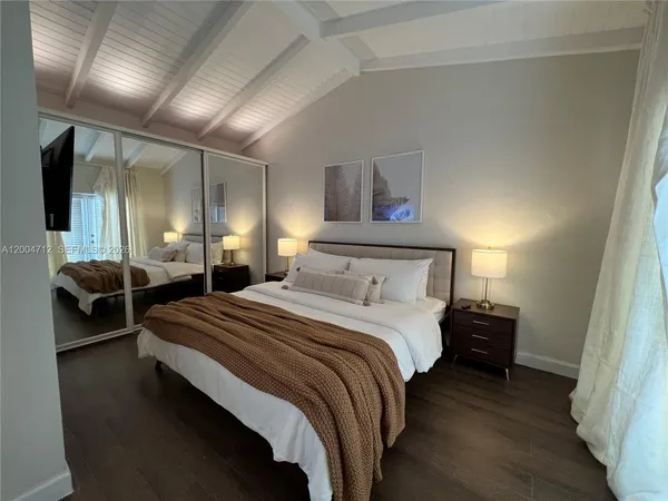 a bedroom with a bed and a painting on the wall