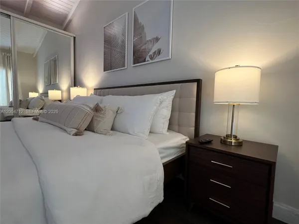 a bedroom with a bed and a night stand