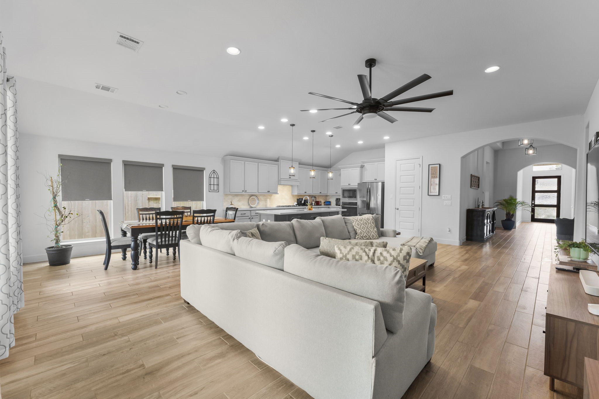17163 Sandstone Street Conroe, TX 77302 - Photo 12 of 31 a living room with furniture a table and kitchen view