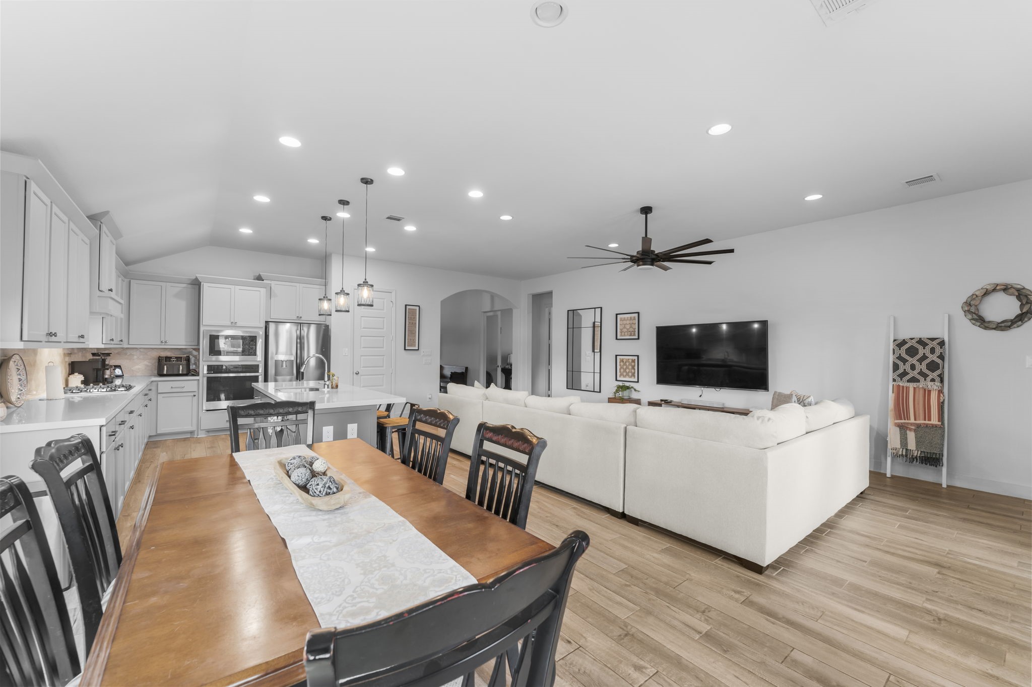 17163 Sandstone Street Conroe, TX 77302 - Photo 15 of 31 a living room with furniture a flat screen tv and kitchen view