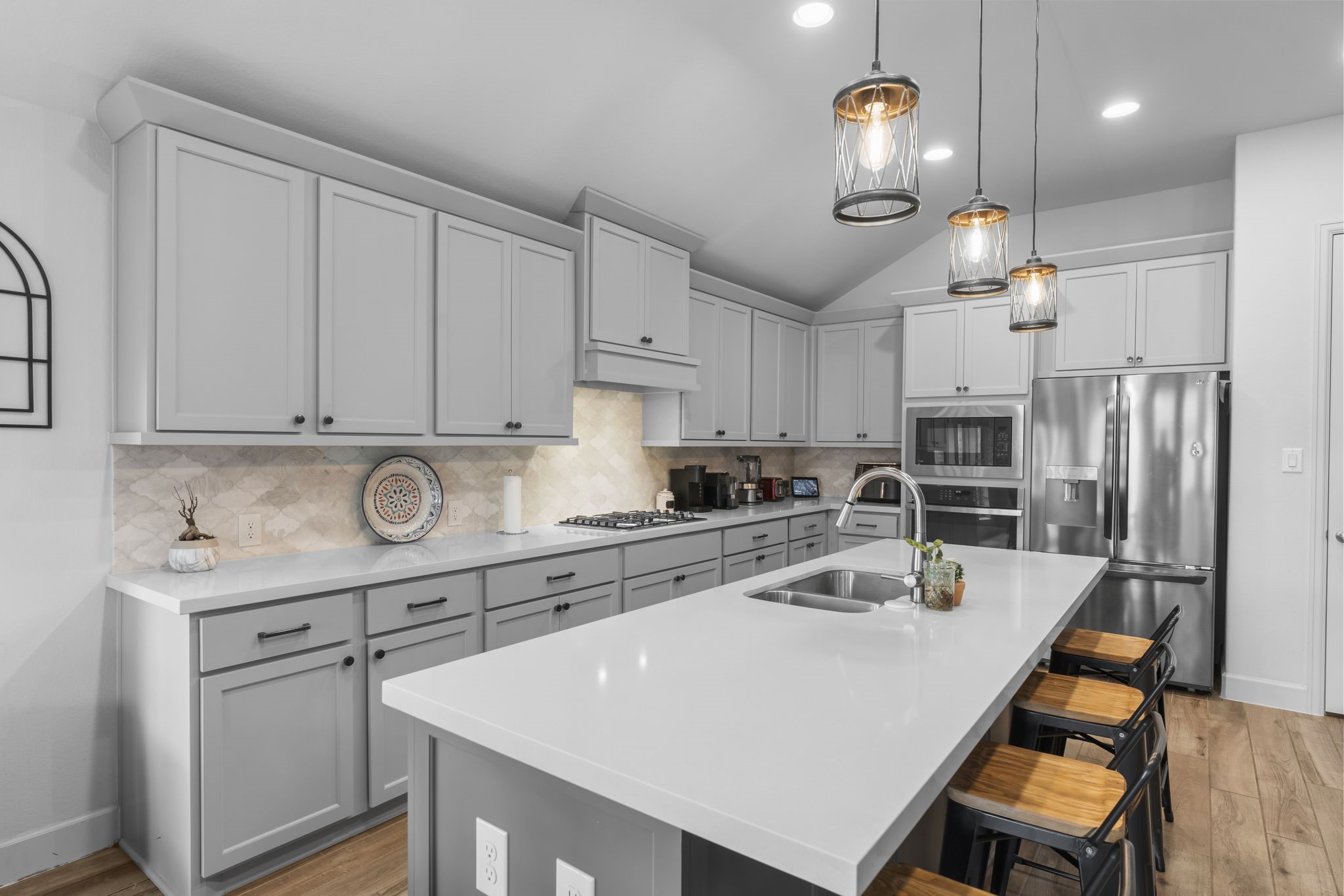 17163 Sandstone Street Conroe, TX 77302 - Photo 16 of 31 a kitchen with a sink a stove a refrigerator and cabinets