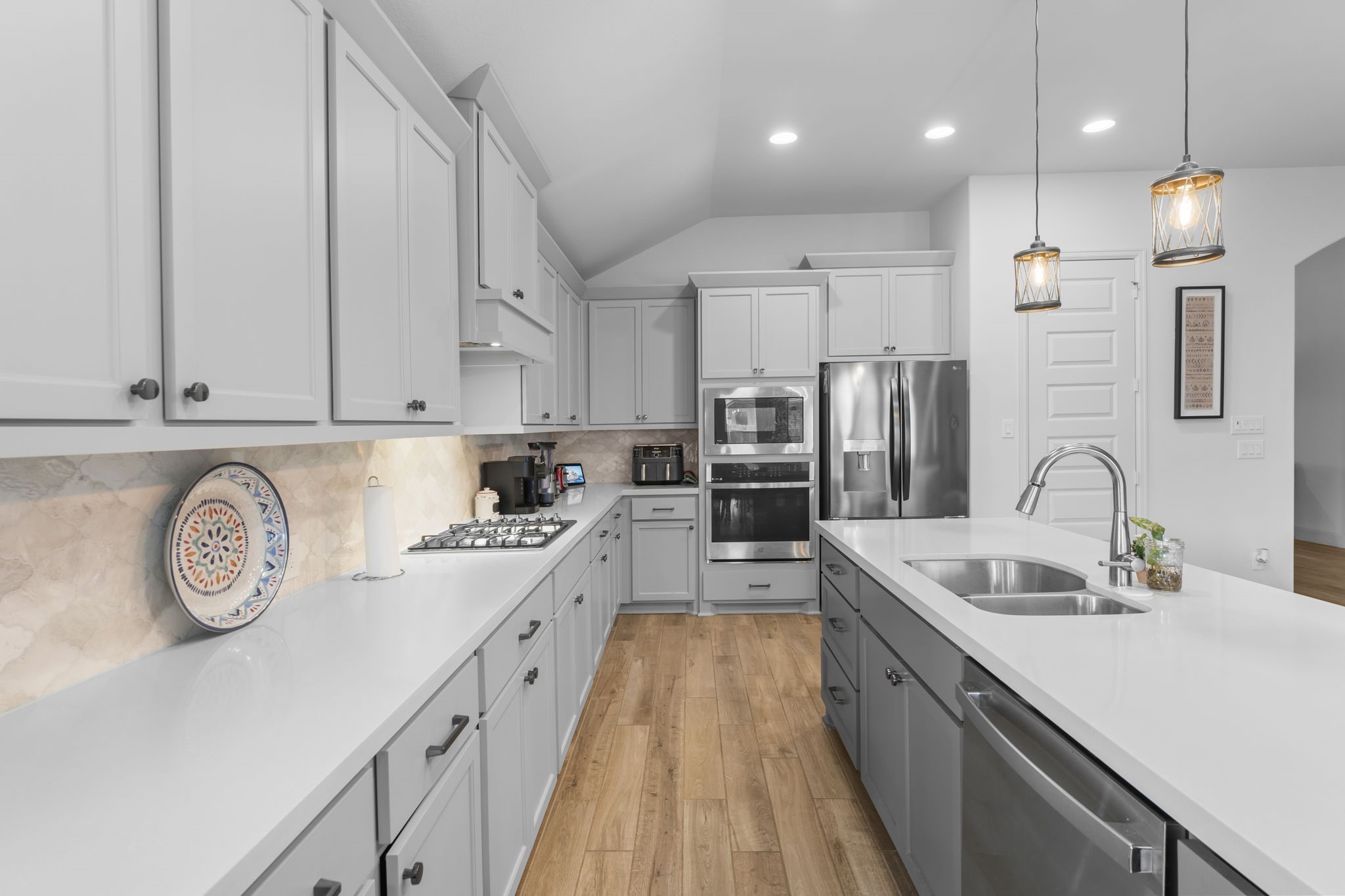 17163 Sandstone Street Conroe, TX 77302 - Photo 17 of 31 a large kitchen with stainless steel appliances granite countertop a sink a stove and a refrigerator