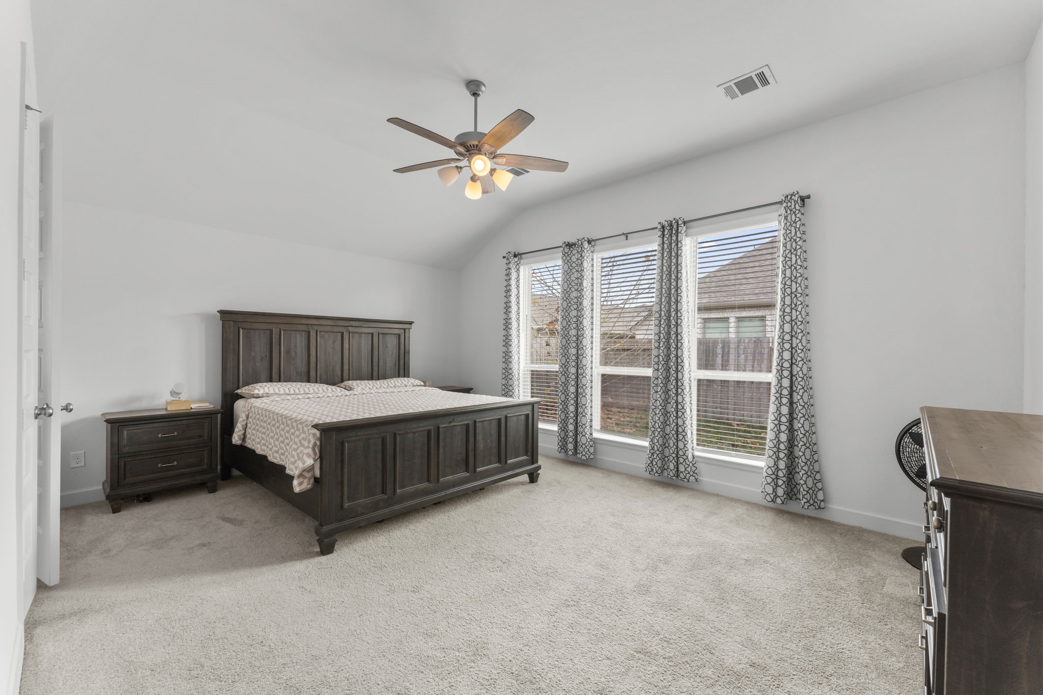 17163 Sandstone Street Conroe, TX 77302 - Photo 21 of 31 a bedroom with a bed and a chandelier