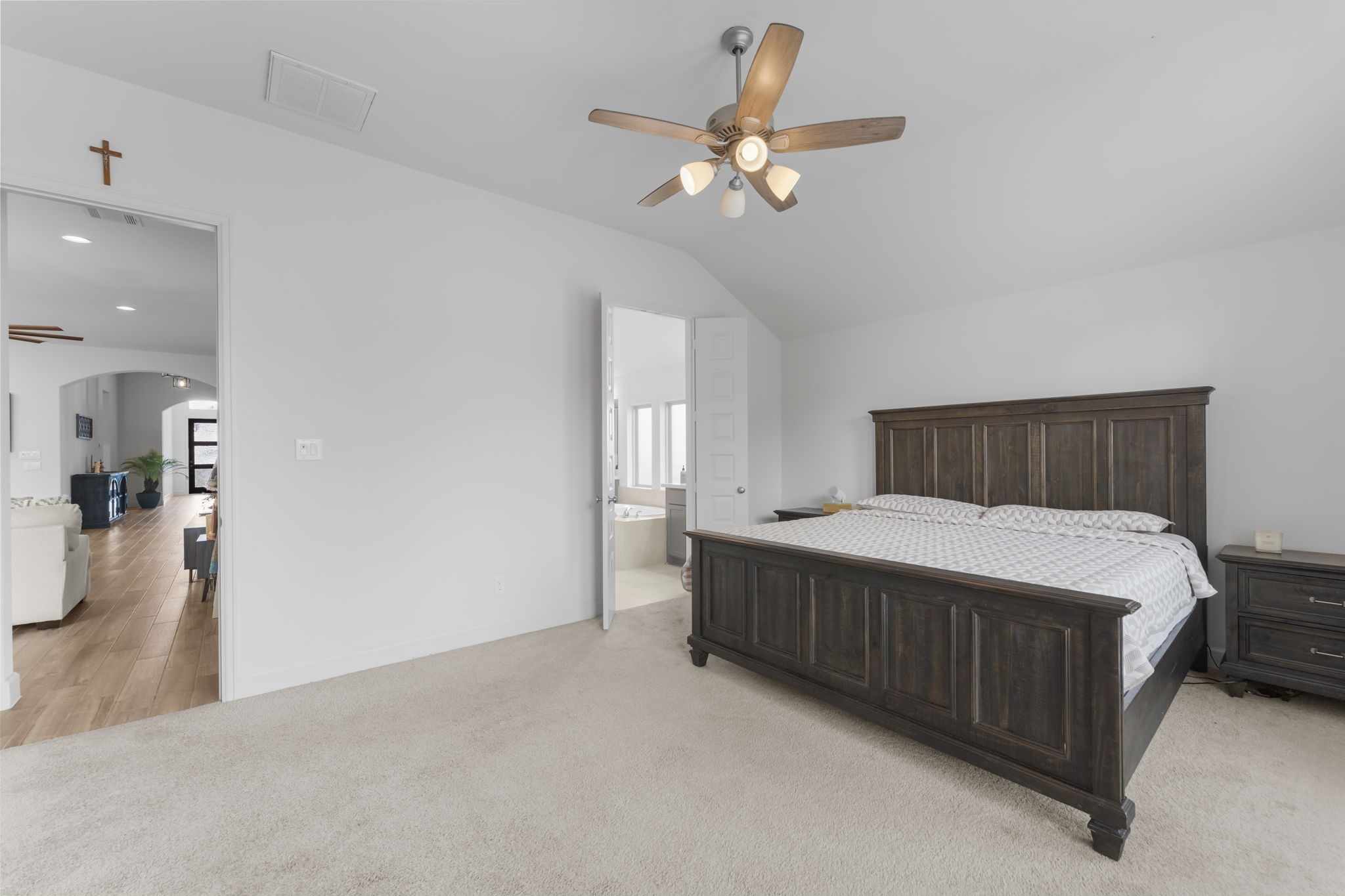 17163 Sandstone Street Conroe, TX 77302 - Photo 22 of 31 a bedroom with a bed and a chandelier