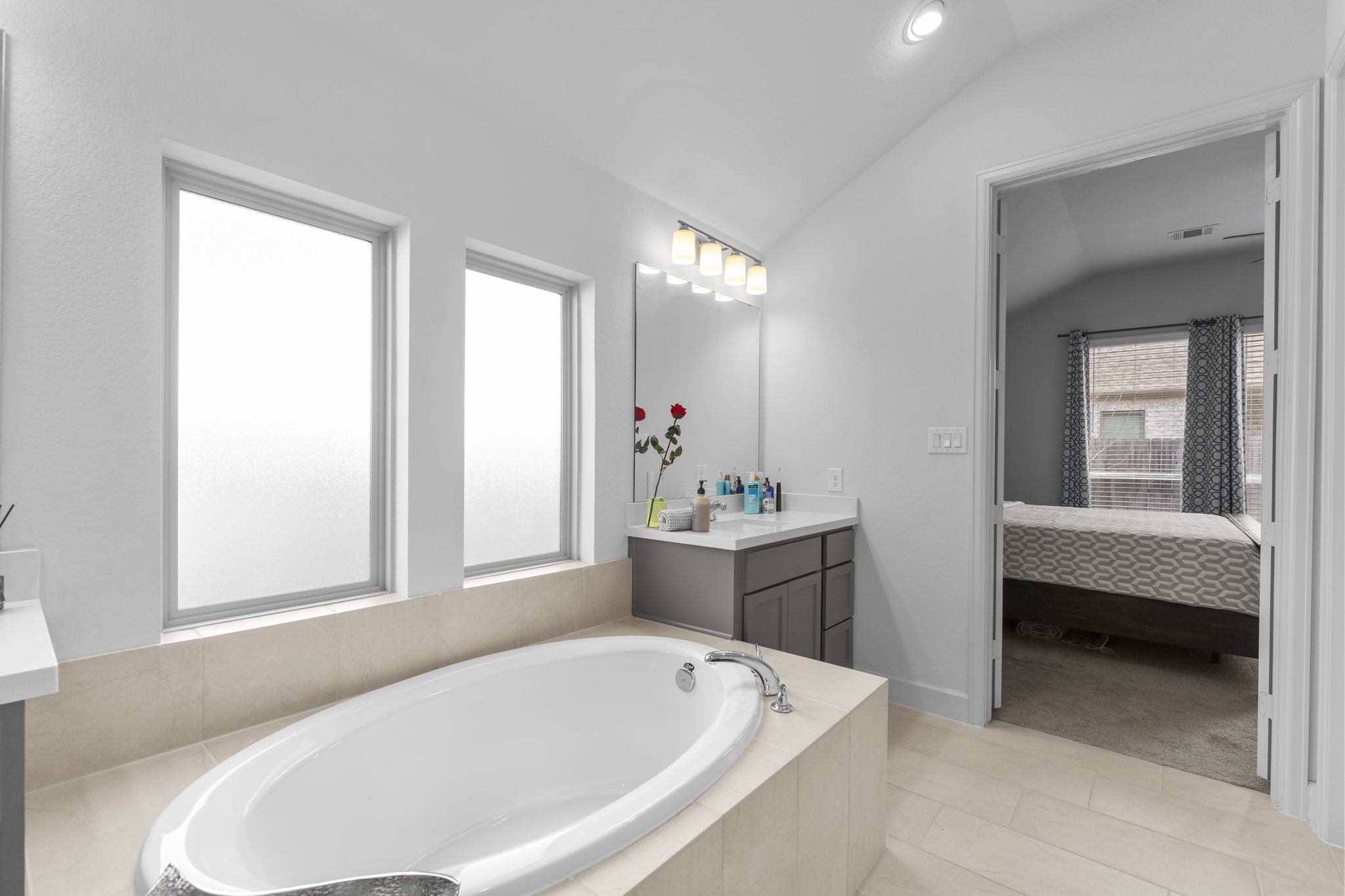 17163 Sandstone Street Conroe, TX 77302 - Photo 26 of 31 a bathroom with a tub sink and window