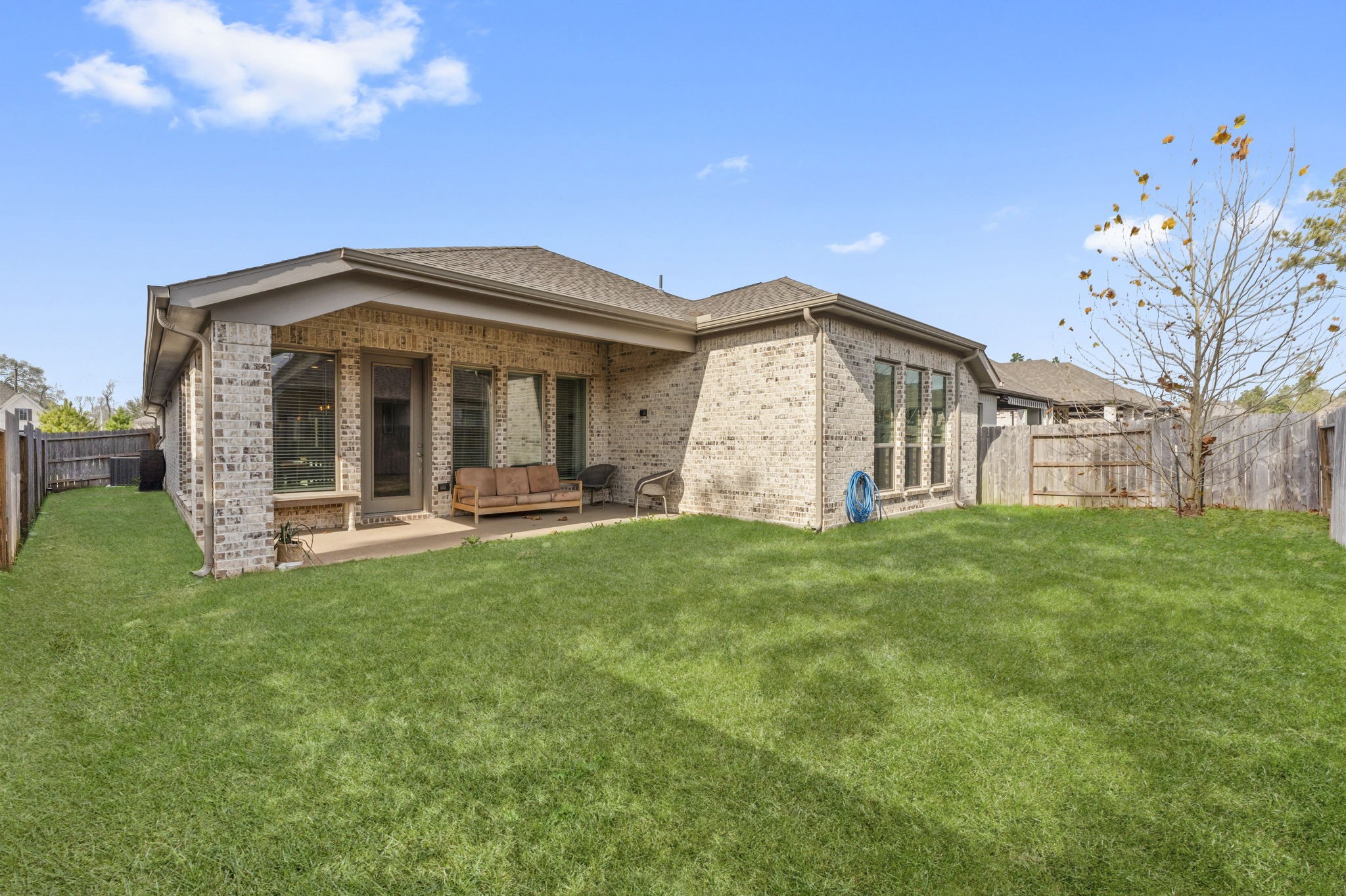 17163 Sandstone Street Conroe, TX 77302 - Photo 30 of 31 a front view of a house with a garden