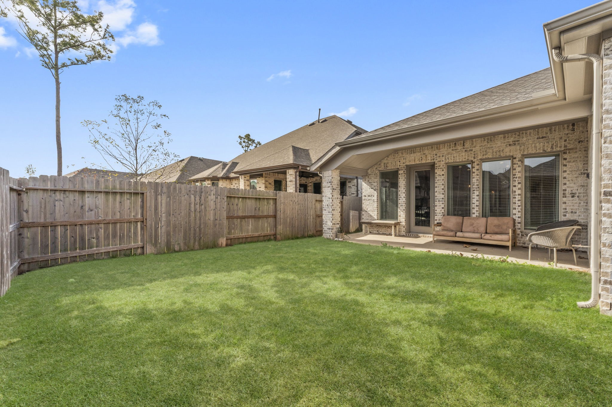 17163 Sandstone Street Conroe, TX 77302 - Photo 31 of 31 a view of a house with backyard porch and wooden fence