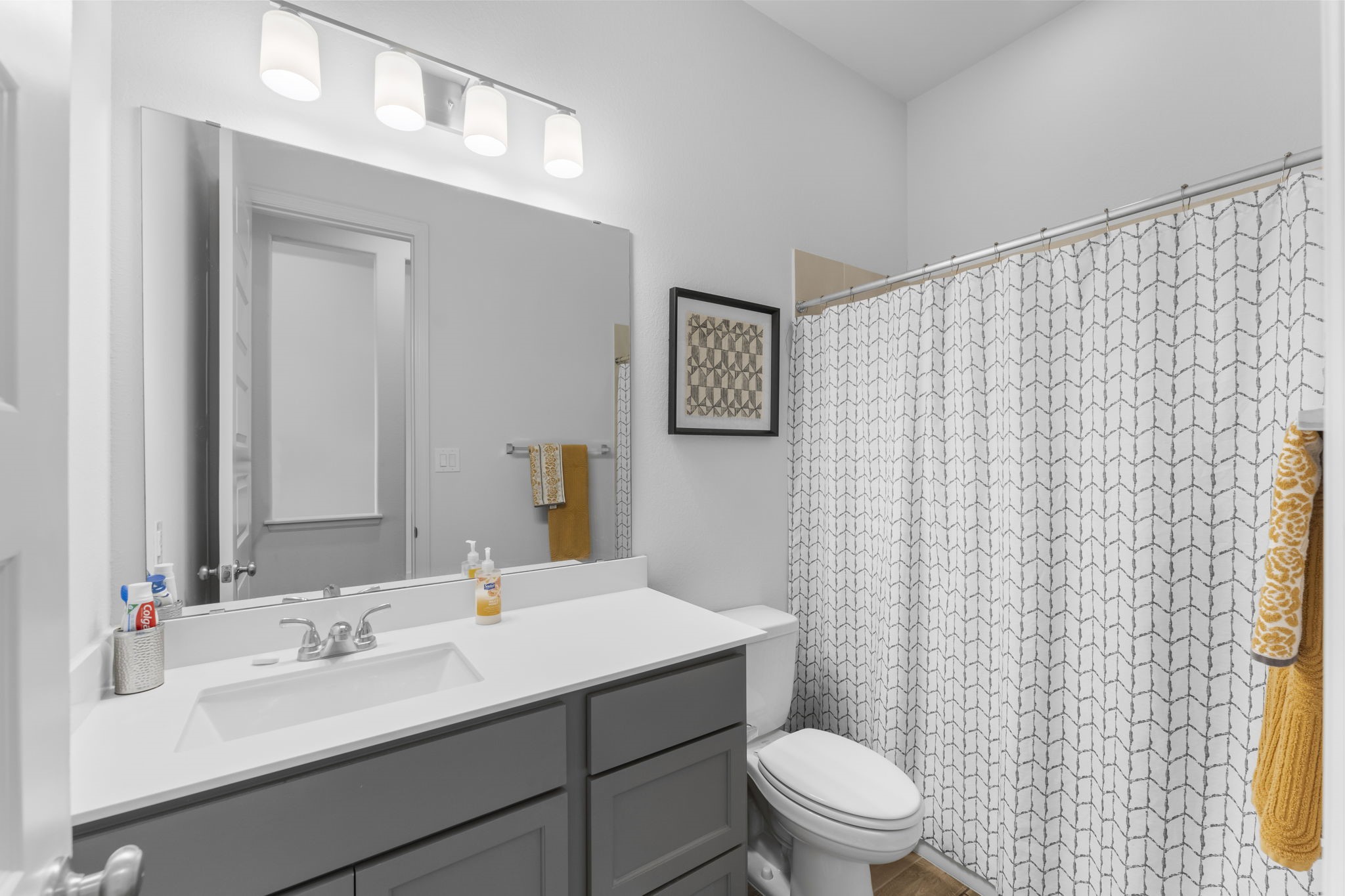 17163 Sandstone Street Conroe, TX 77302 - Photo 5 of 31 a bathroom with a sink a toilet and a mirror