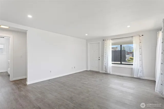 an empty room with a empty space and windows