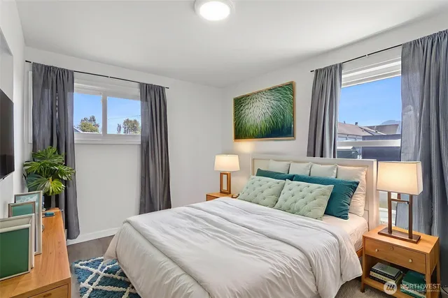 a bedroom with a bed and a potted plant