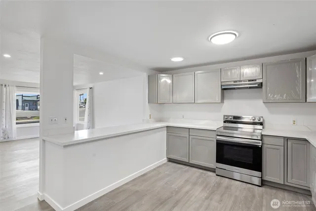 a kitchen with stainless steel appliances granite countertop a stove and a sink