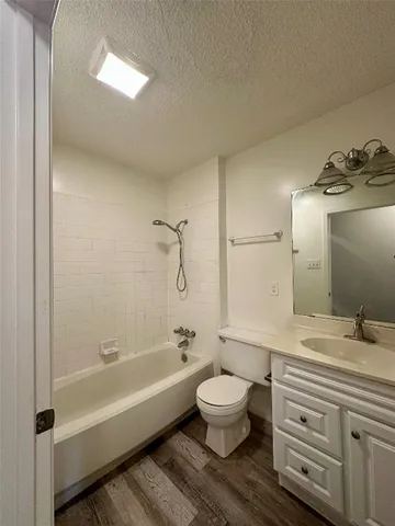 a bathroom with a bathtub shower sink and toilet