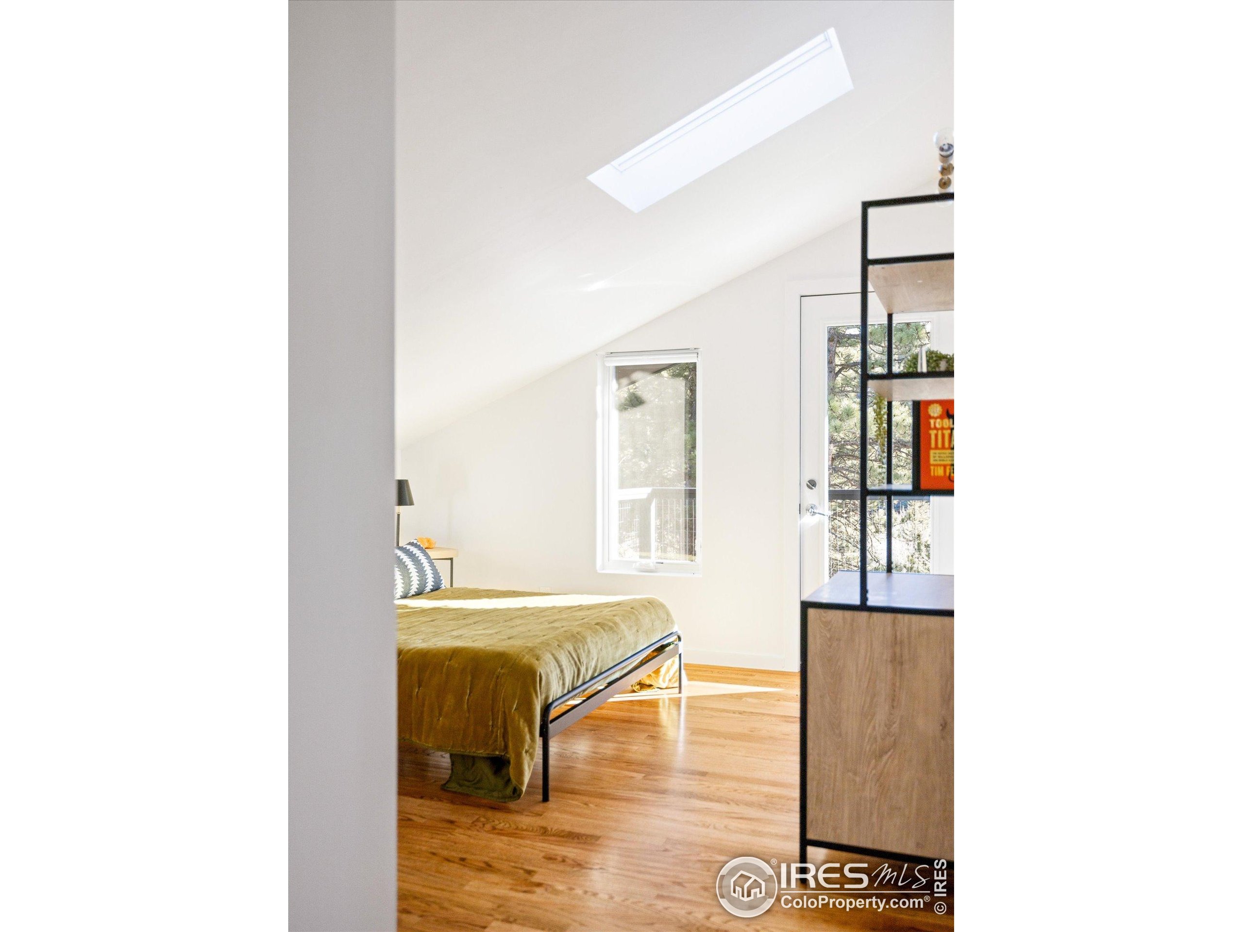 781 Cold Springs Road Boulder, CO 80302 - Photo 14 of 36 a living room with couches and kitchen view with wooden floor