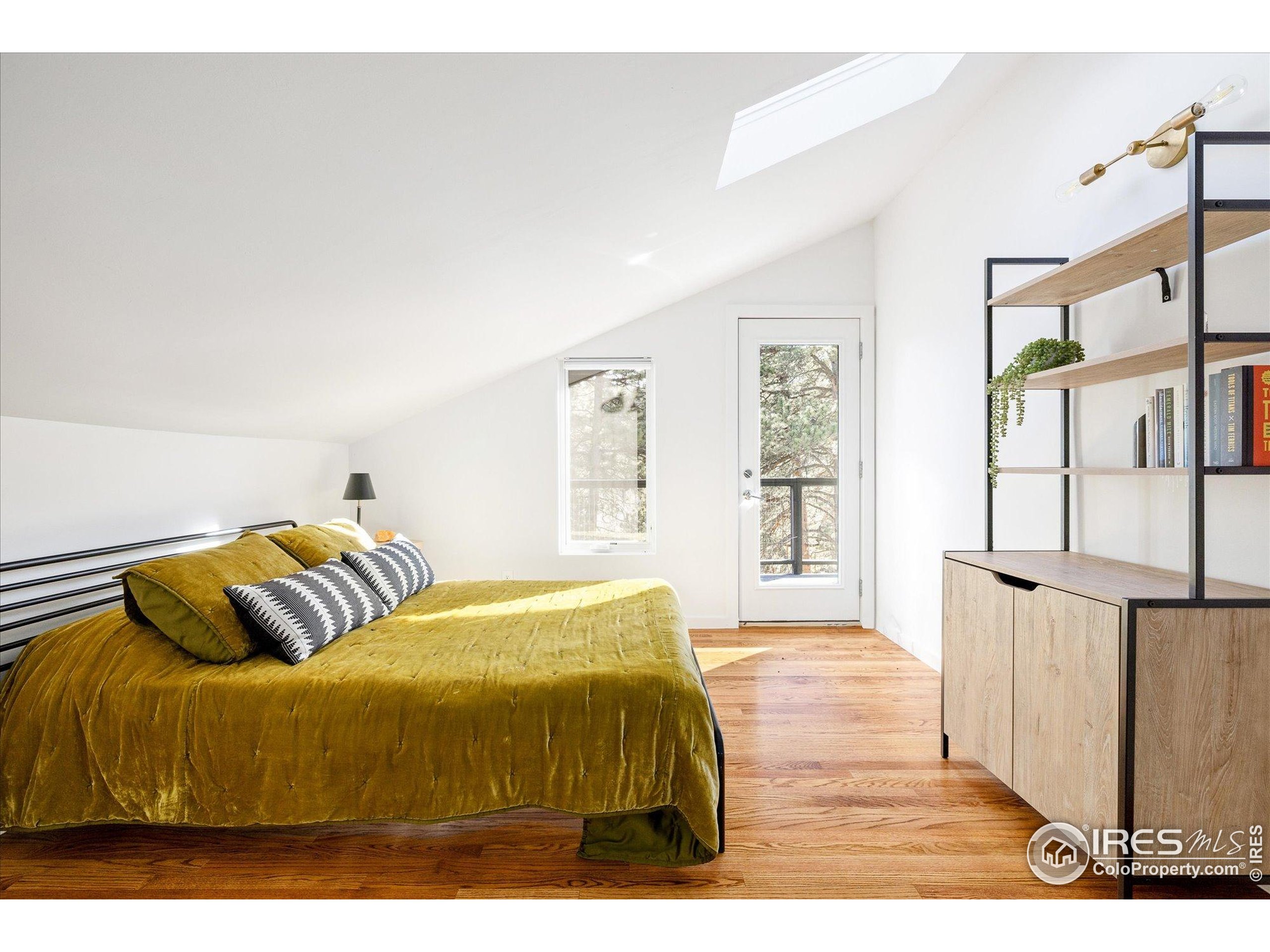 781 Cold Springs Road Boulder, CO 80302 - Photo 15 of 36 a bedroom with a bed and wooden floor