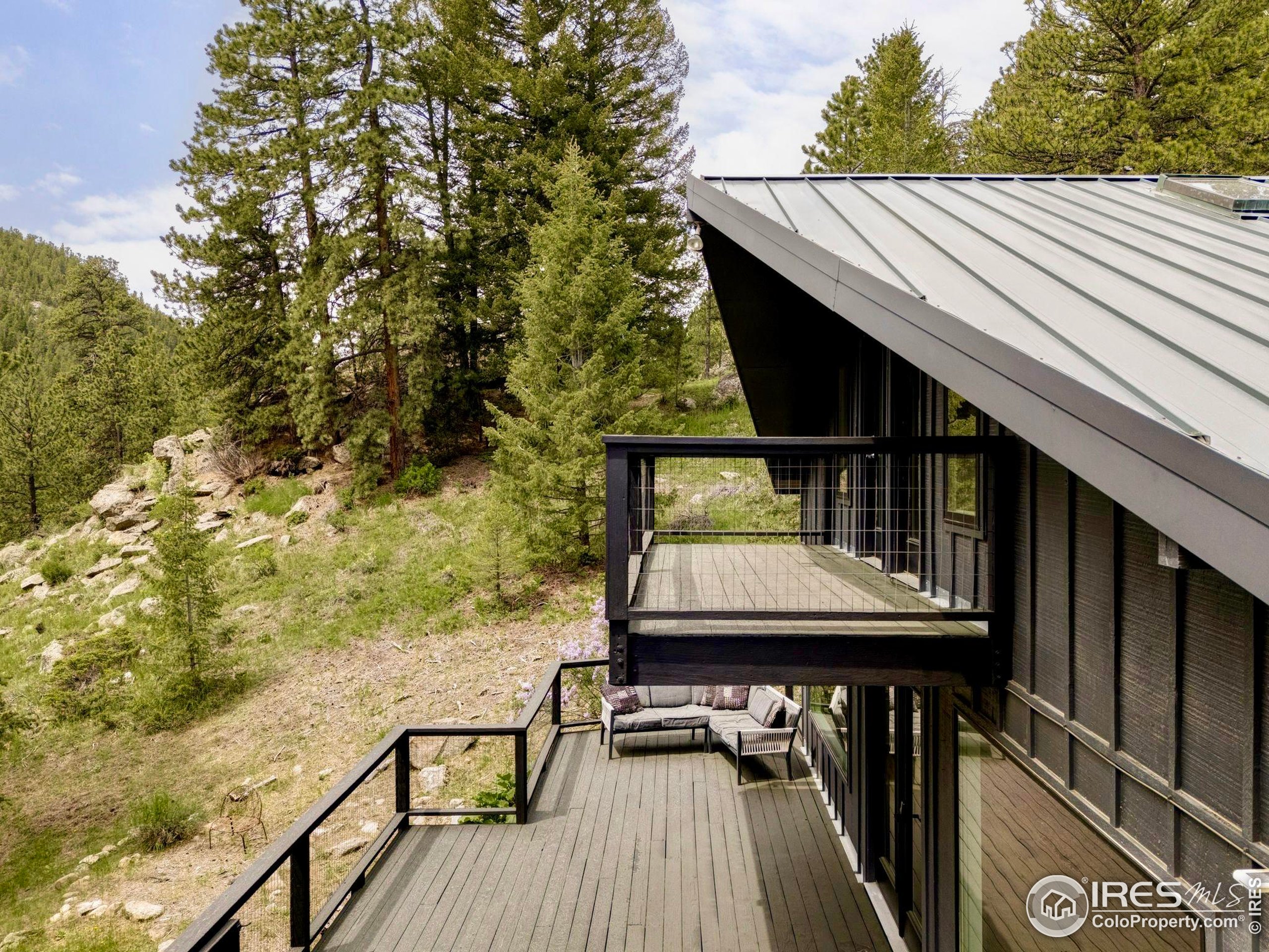 781 Cold Springs Road Boulder, CO 80302 - Photo 28 of 36 a view of balcony with wooden floor and outdoor seating