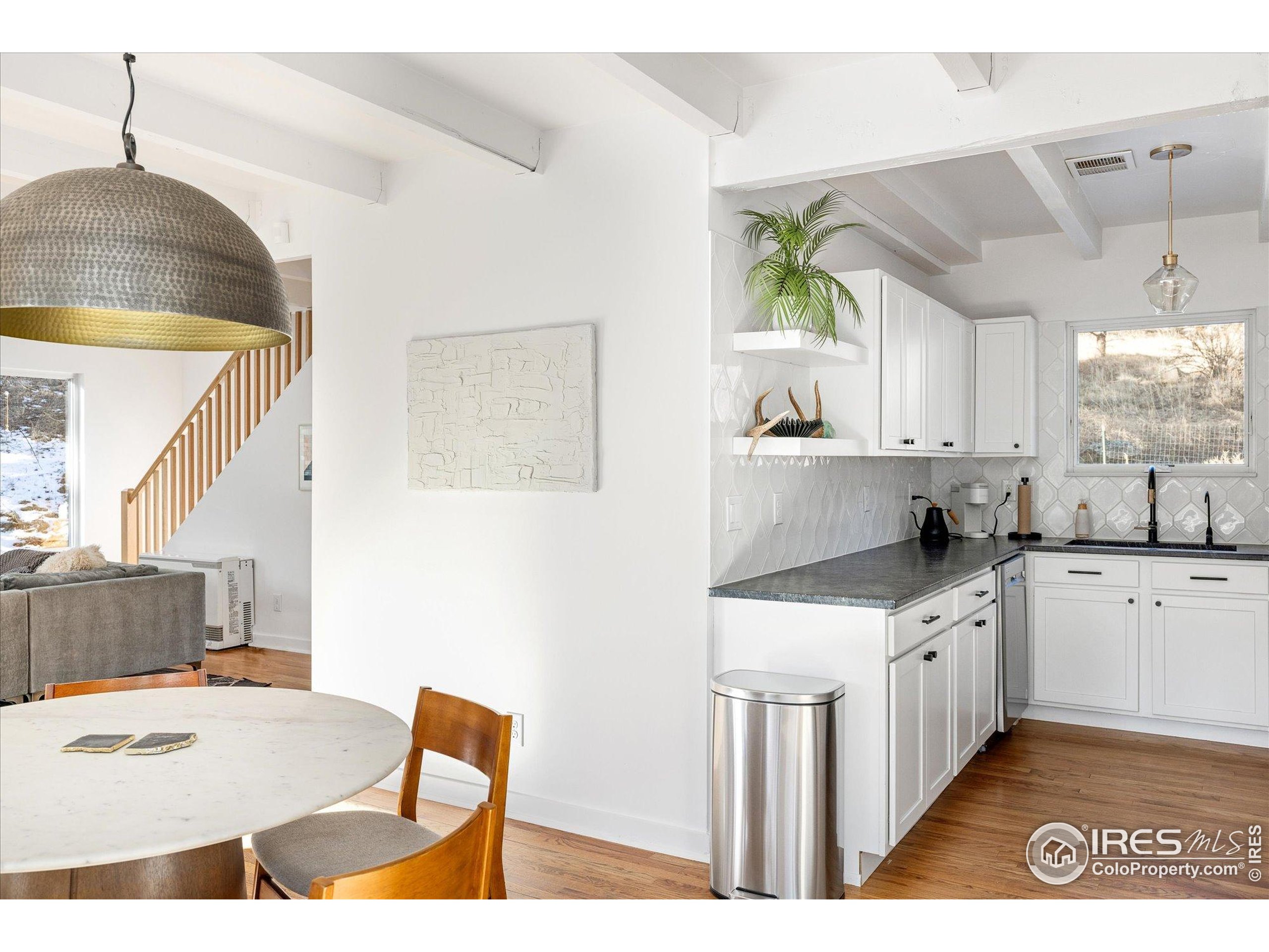 781 Cold Springs Road Boulder, CO 80302 - Photo 6 of 36 a kitchen with kitchen island a stove a sink a dining table and chairs