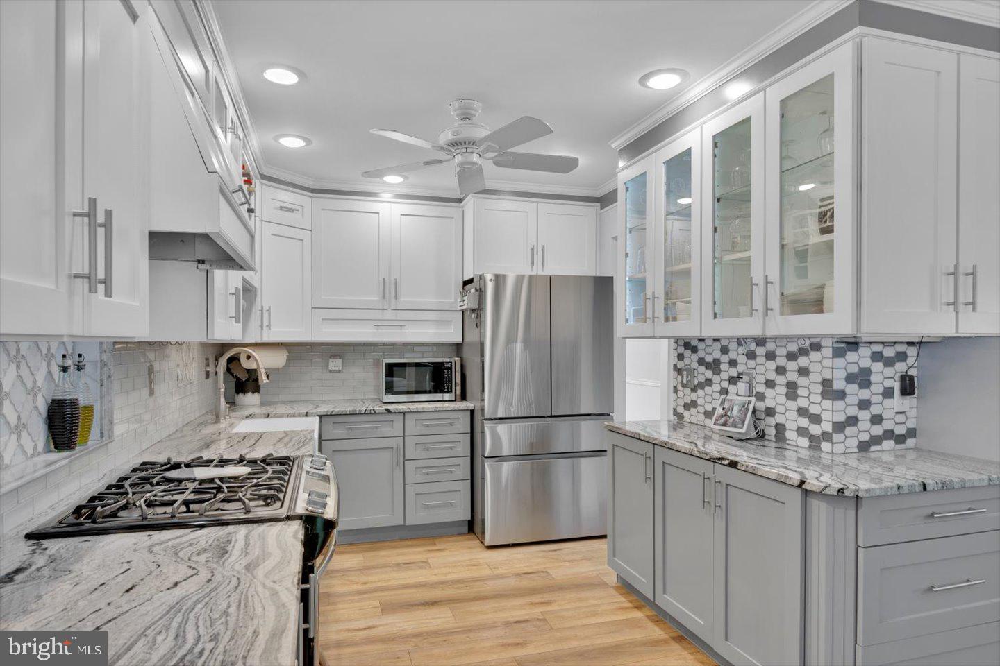 166 Country Farms Road Marlton, NJ 08053 - Photo 13 of 68 a kitchen with granite countertop a refrigerator a sink a stove and white cabinets