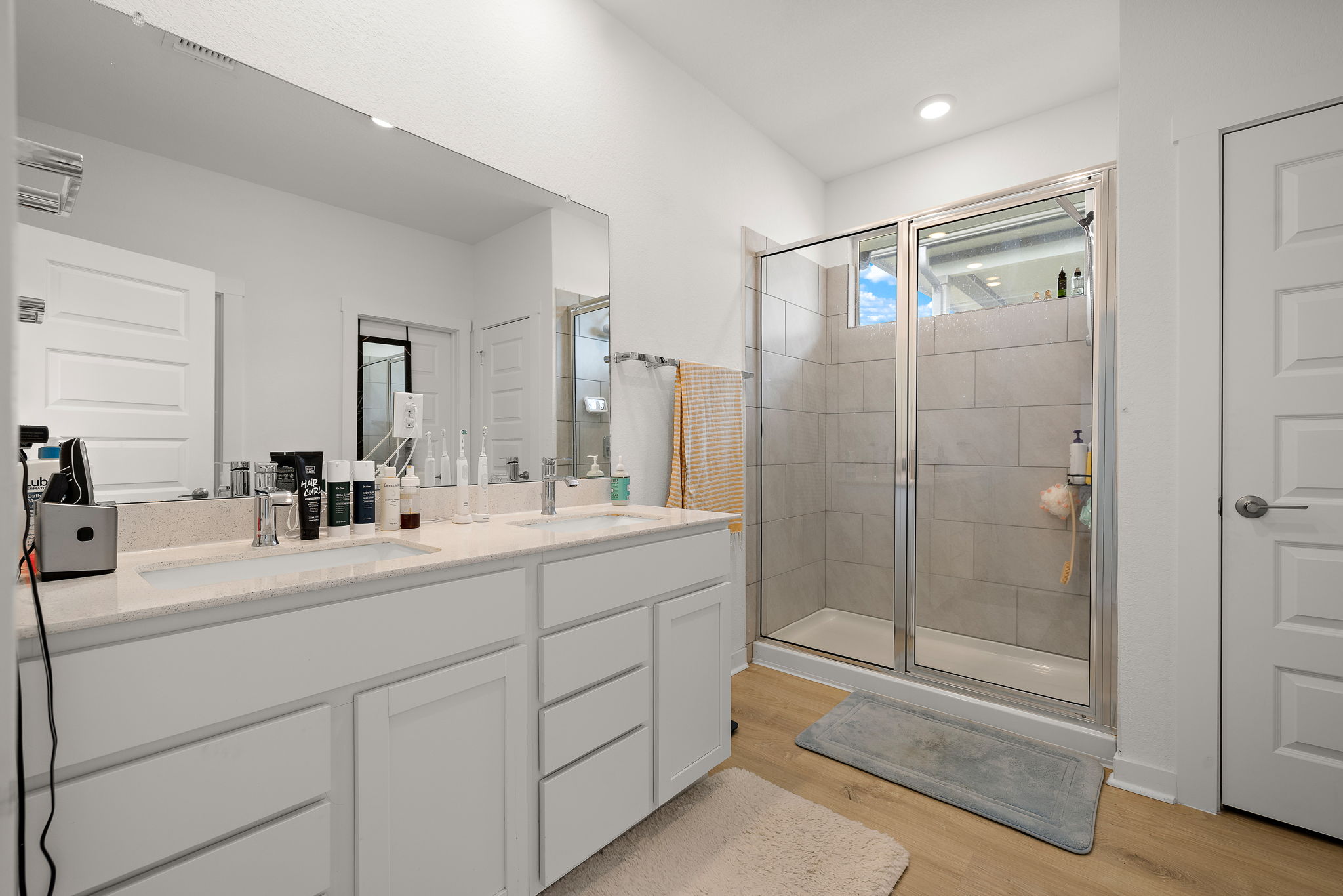 2313 Ranier Court Austin, TX 78754 - Photo 13 of 22 a bathroom with a shower sink vanity and mirror