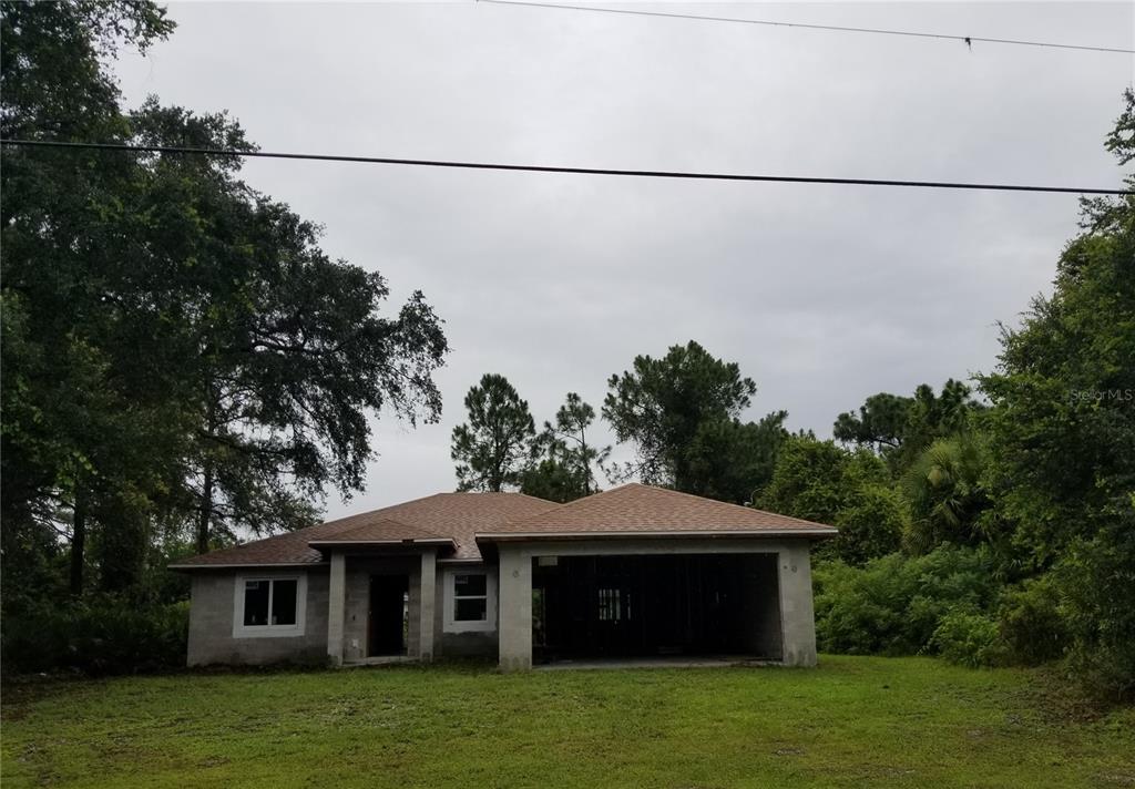 238 Wayne Road Rotonda West, FL 33947 - Photo 1 of 1 a front view of a house with a yard