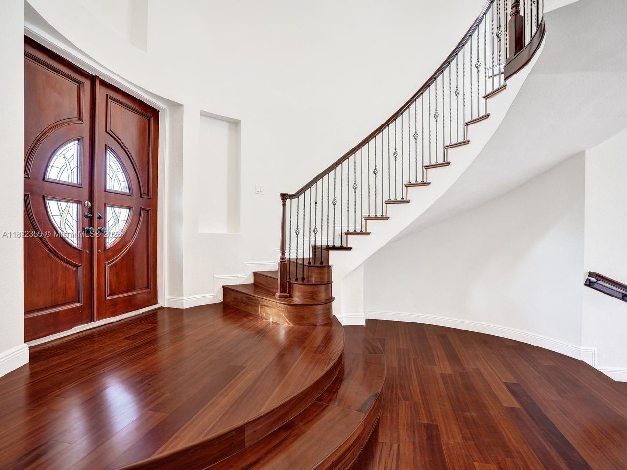 14403 Jockey Circle Davie, FL 33330 - Photo 12 of 53 a view of entryway with wooden floor and stairs