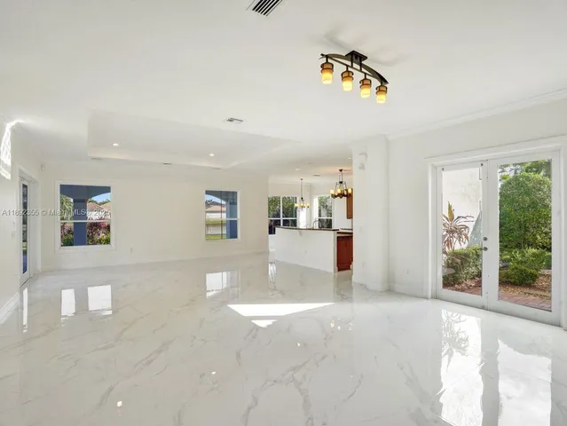 a large living room with stainless steel appliances kitchen island granite countertop a large counter top and couches