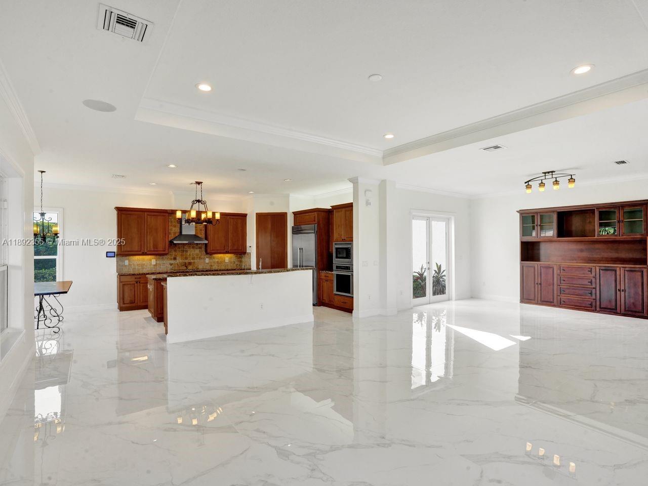 14403 Jockey Circle Davie, FL 33330 - Photo 17 of 53 a large living room with stainless steel appliances kitchen island granite countertop a large counter top and couches