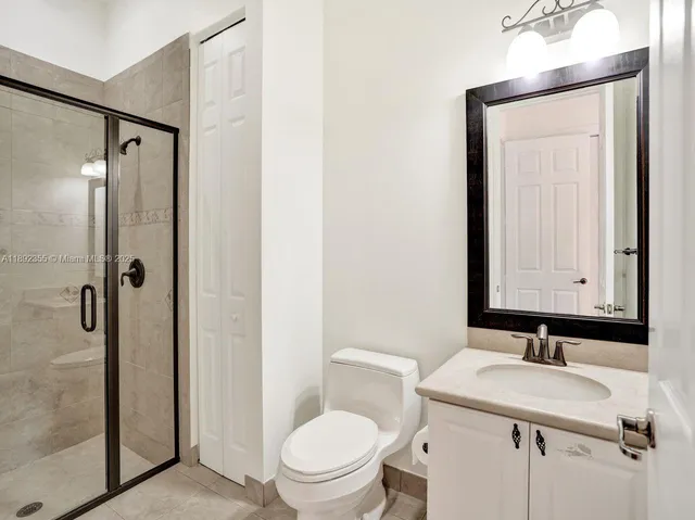 a bathroom with a sink and mirror with toilet