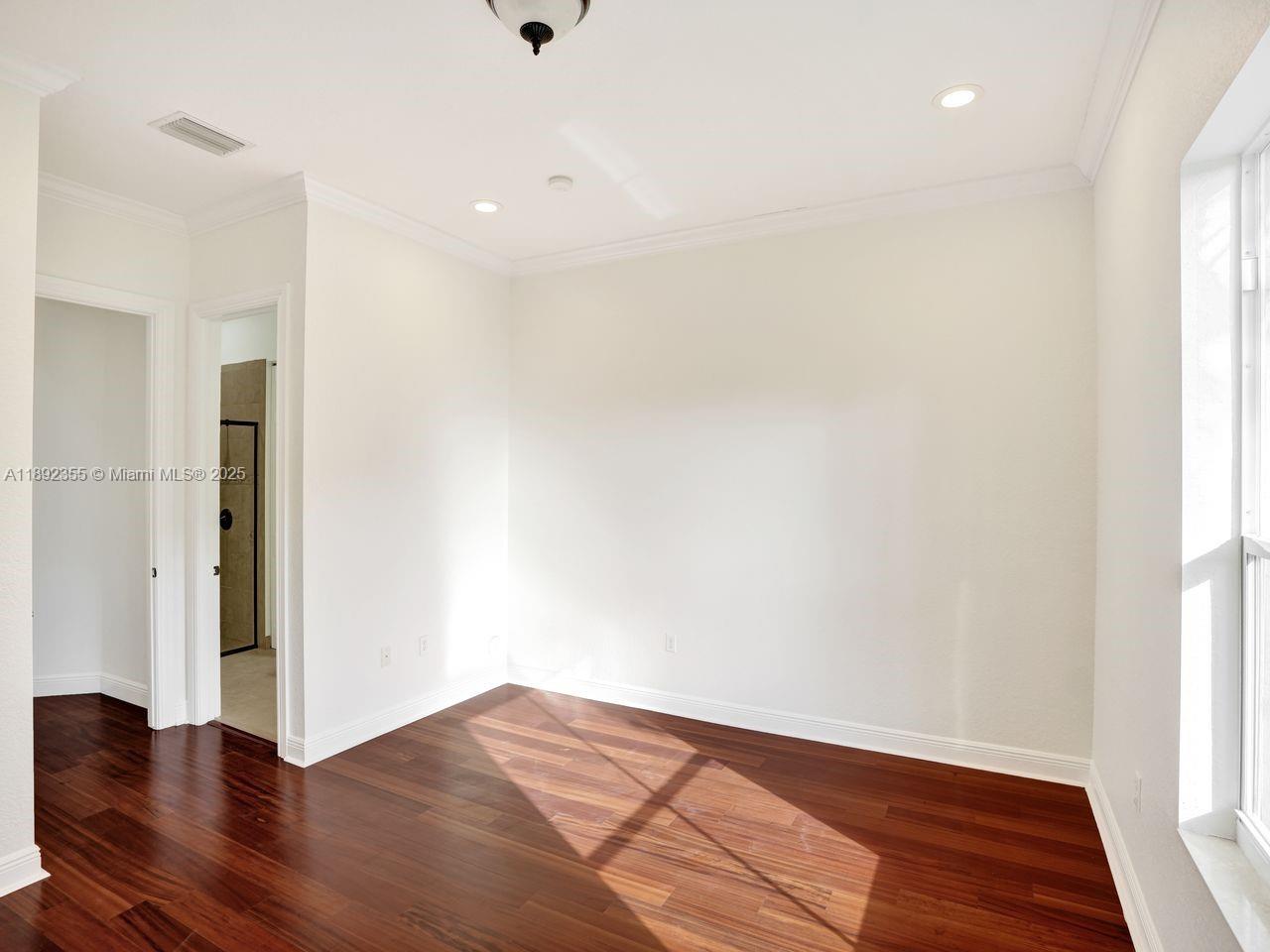 14403 Jockey Circle Davie, FL 33330 - Photo 22 of 53 a view of an empty room with wooden floor and a window