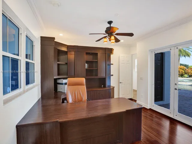 a view of a hallway with wooden floor and stairs