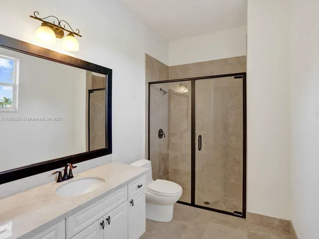 an empty room with closet and windows