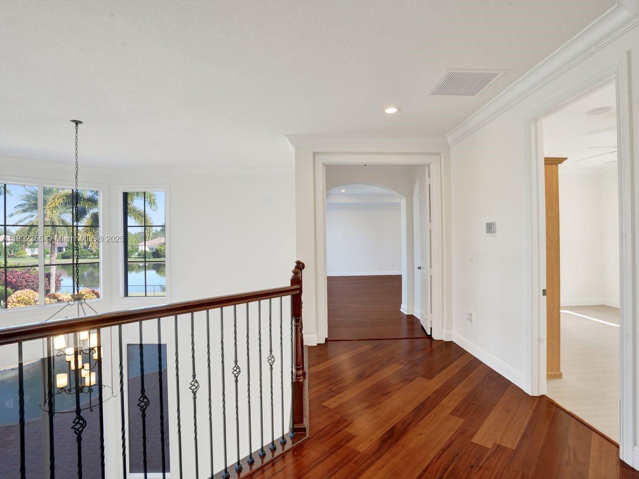 14403 Jockey Circle Davie, FL 33330 - Photo 26 of 53 a view of a hallway with wooden floor and stairs
